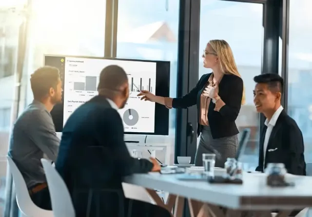 Finance team reviewing spreadsheet dashboards during a planning meeting